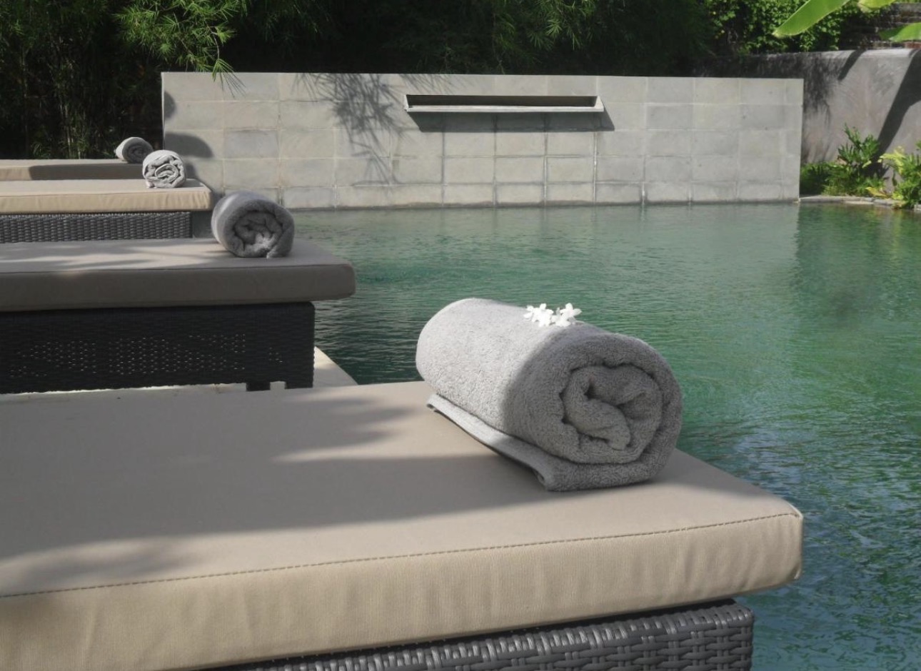 Detalle de toallas enrolladas junto a la piscina